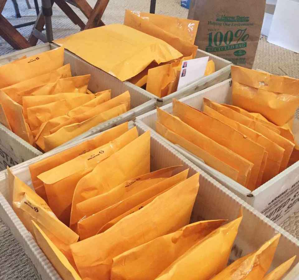 Boxes of books backaged in manila envelopes.